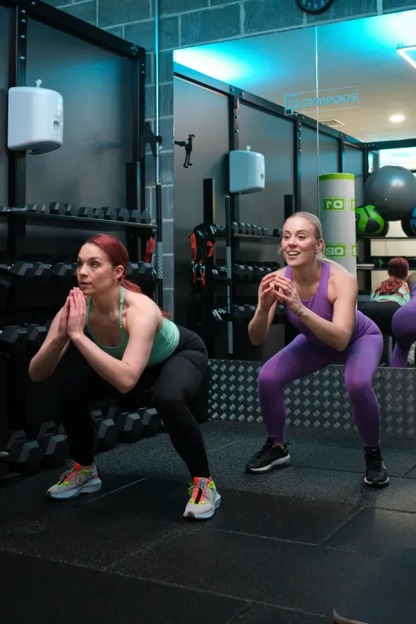 Two people training together in a private GYMPODS pod