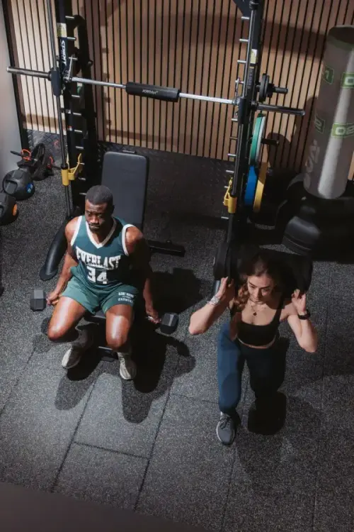 Two people training together in a private Power POD at GYMPODS Putney