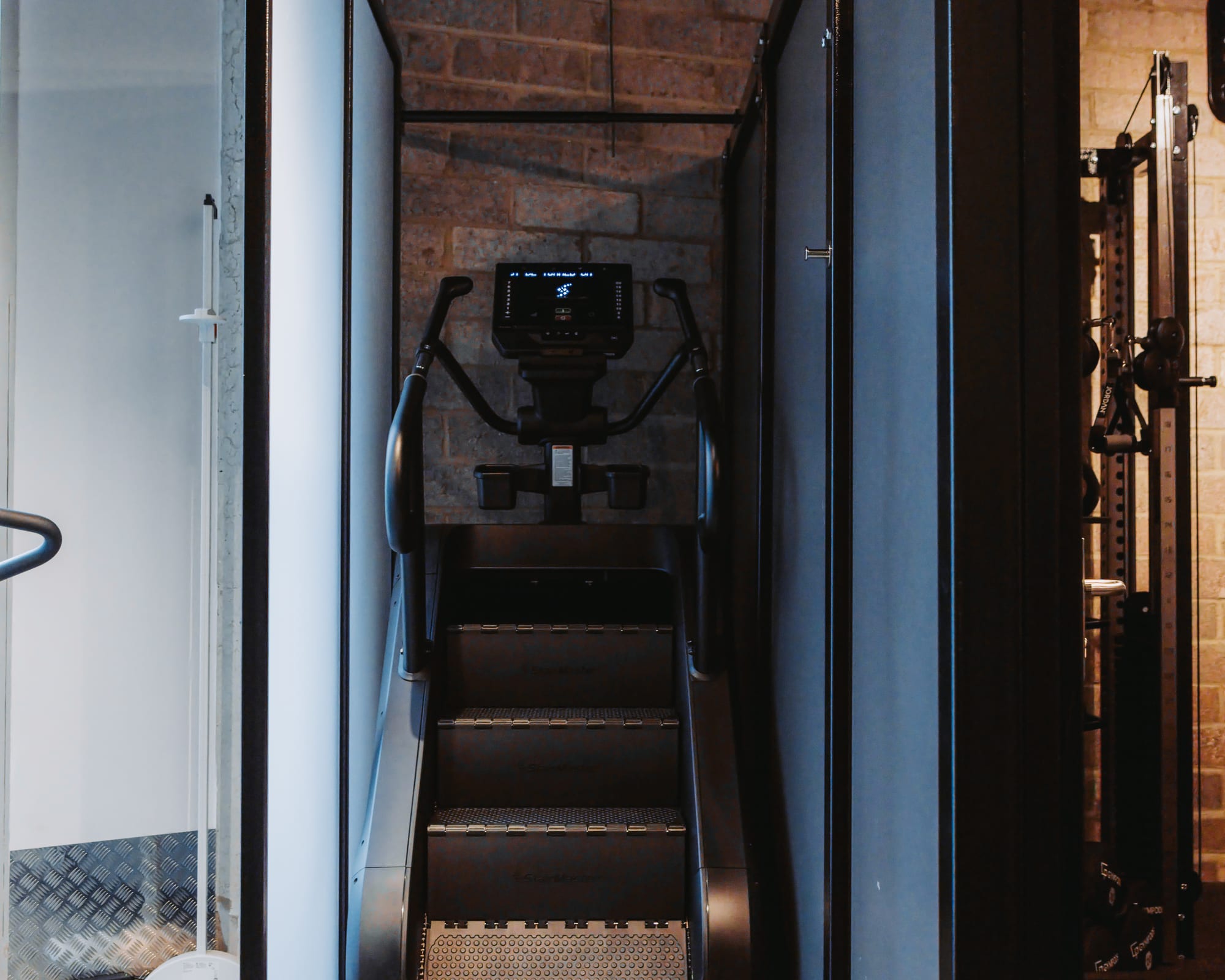StairMaster in a visually private cardio bay at GYMPODS Putney